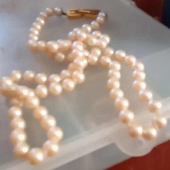 Givenchy pearl necklace with gold tone clasp.In Excellent Mint Unused Condition